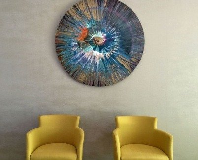 Blue spin art and two mustard yellow chairs