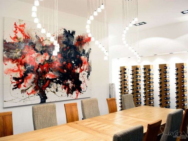 Red and gold art in a dining room with wine cellar