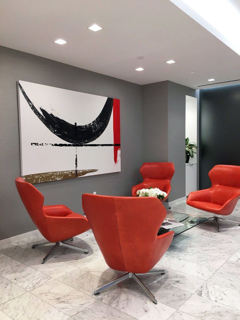 Red and white abstract painting in an office reception