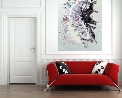 Freefall painting hanging above a red sofa