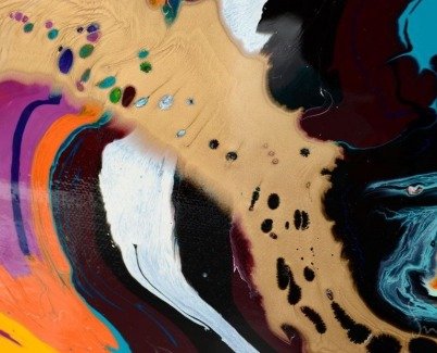 close-up view of swirling multi-coloured paint close-up view of swirling multi-coloured paint