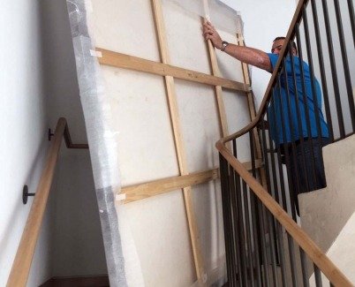 Carrying-a-large-painting-upstairs