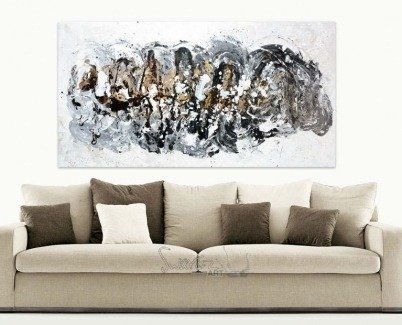 Beige sofa and black and gold art above it