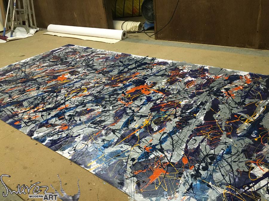 Working on a large drip painting