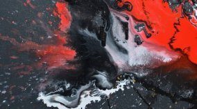 red and black paints on a black canvas