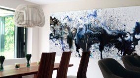 Large blue and black art in a dining room