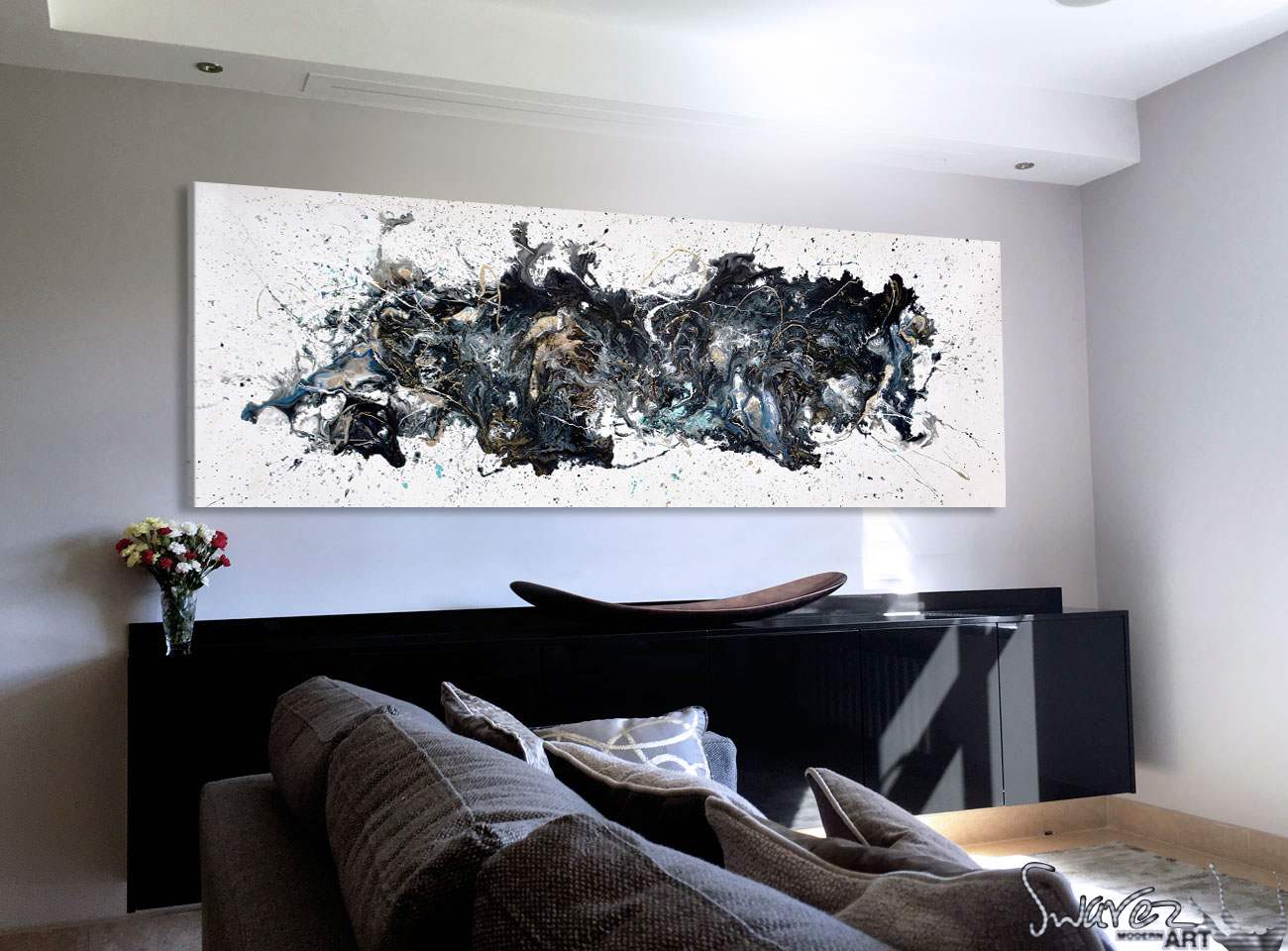 Black and white abstract painting hung on a living room wall