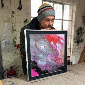 Swarez holding a painting