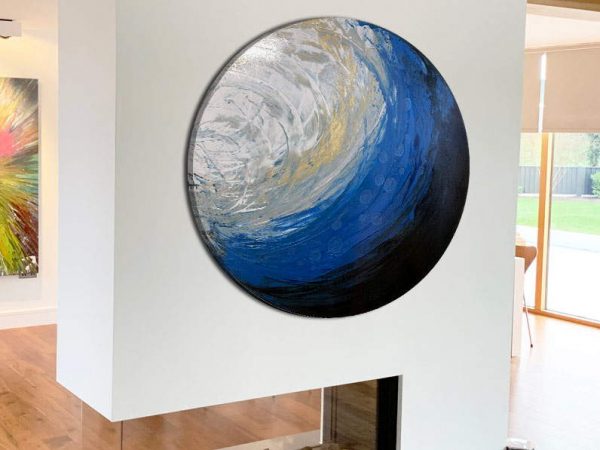 round canvas art on a fireplace