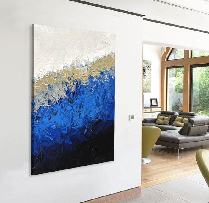 black and gold and blue art hanging on a wall