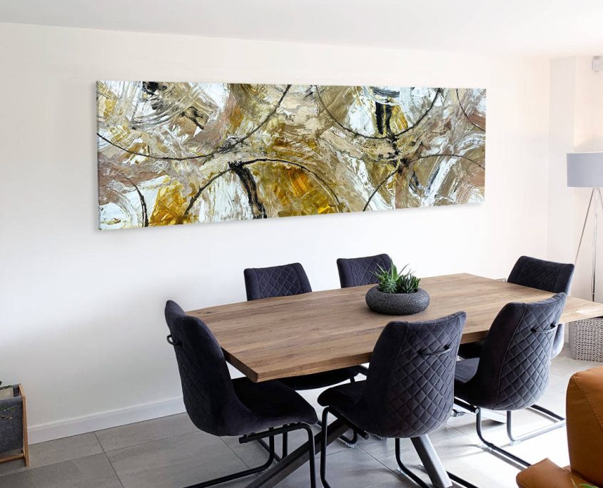 gold colored abstract painting above a dining table