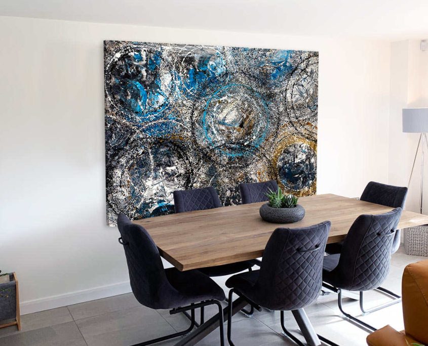dining table and chairs with large blue abstract art